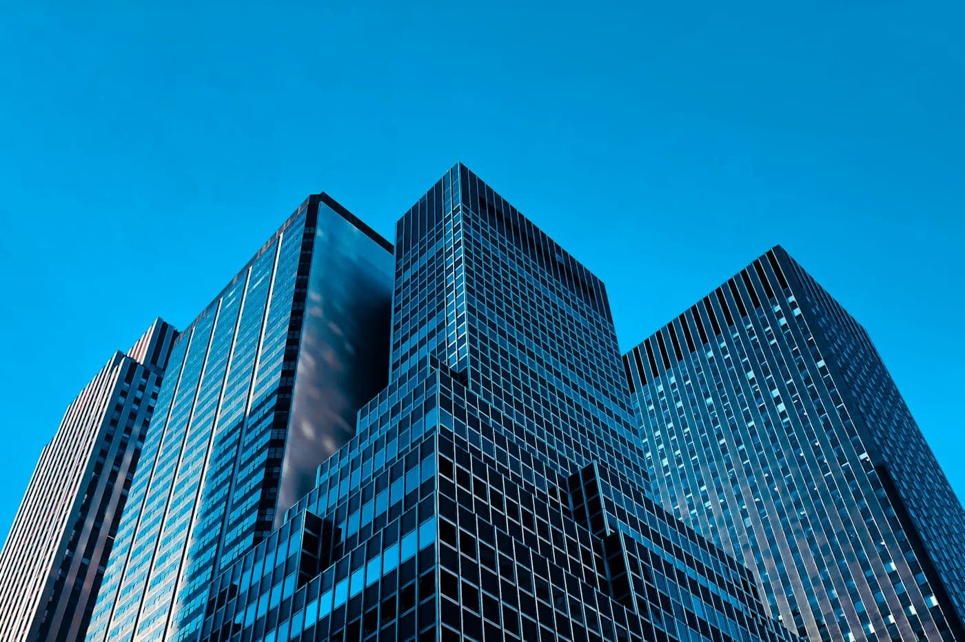 Glass office towers against a clear blue sky